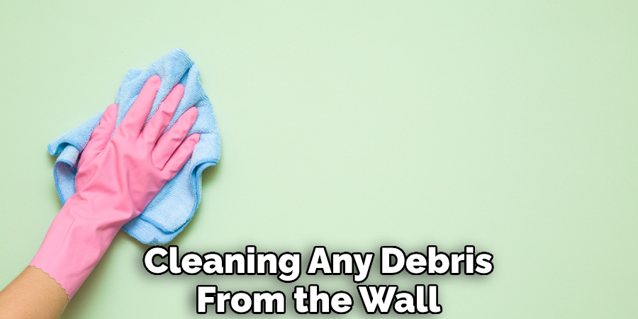 Cleaning Any Debris From the Wall