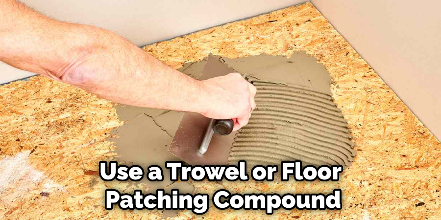 Use a Trowel or Floor Patching Compound