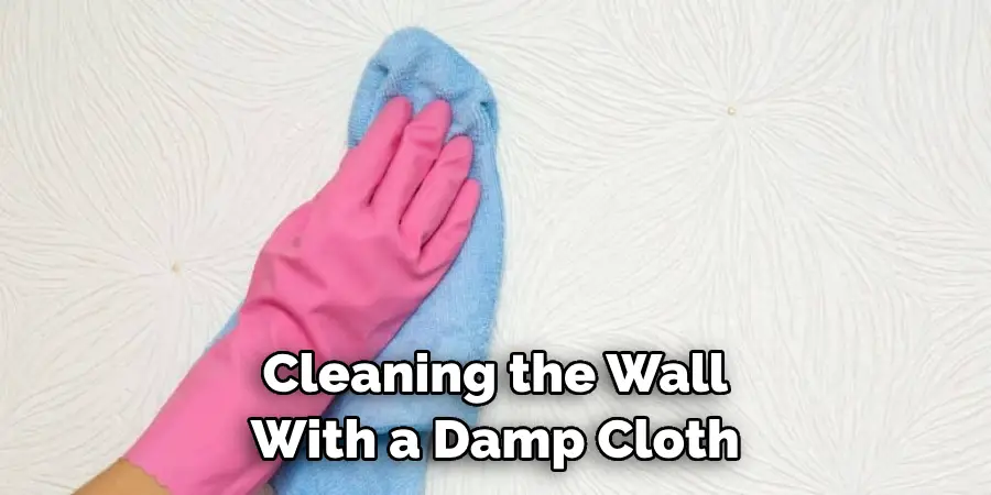 Cleaning the Wall With a Damp Cloth