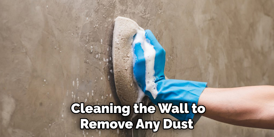 Cleaning the Wall to Remove Any Dust 