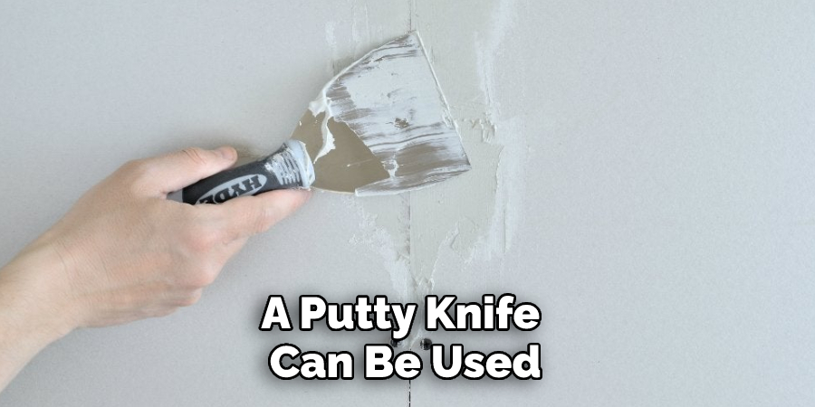 A putty knife can be used