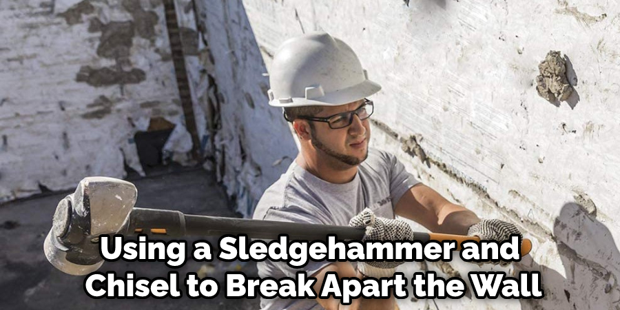 Using a Sledgehammer and Chisel to Break Apart the Wall