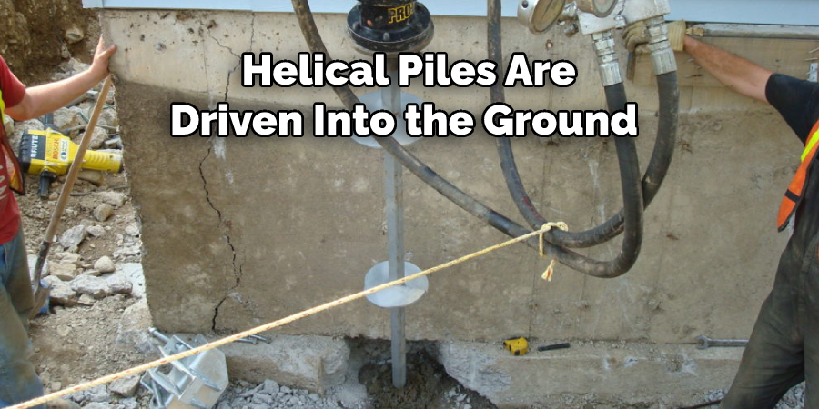 Helical Piles Are Driven Into the Ground 