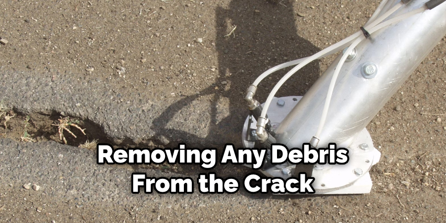 removing any debris from the crack