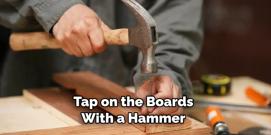 Tap on the Boards With a Hammer