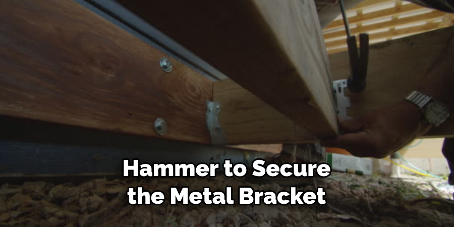 Hammer to Secure the Metal Bracket